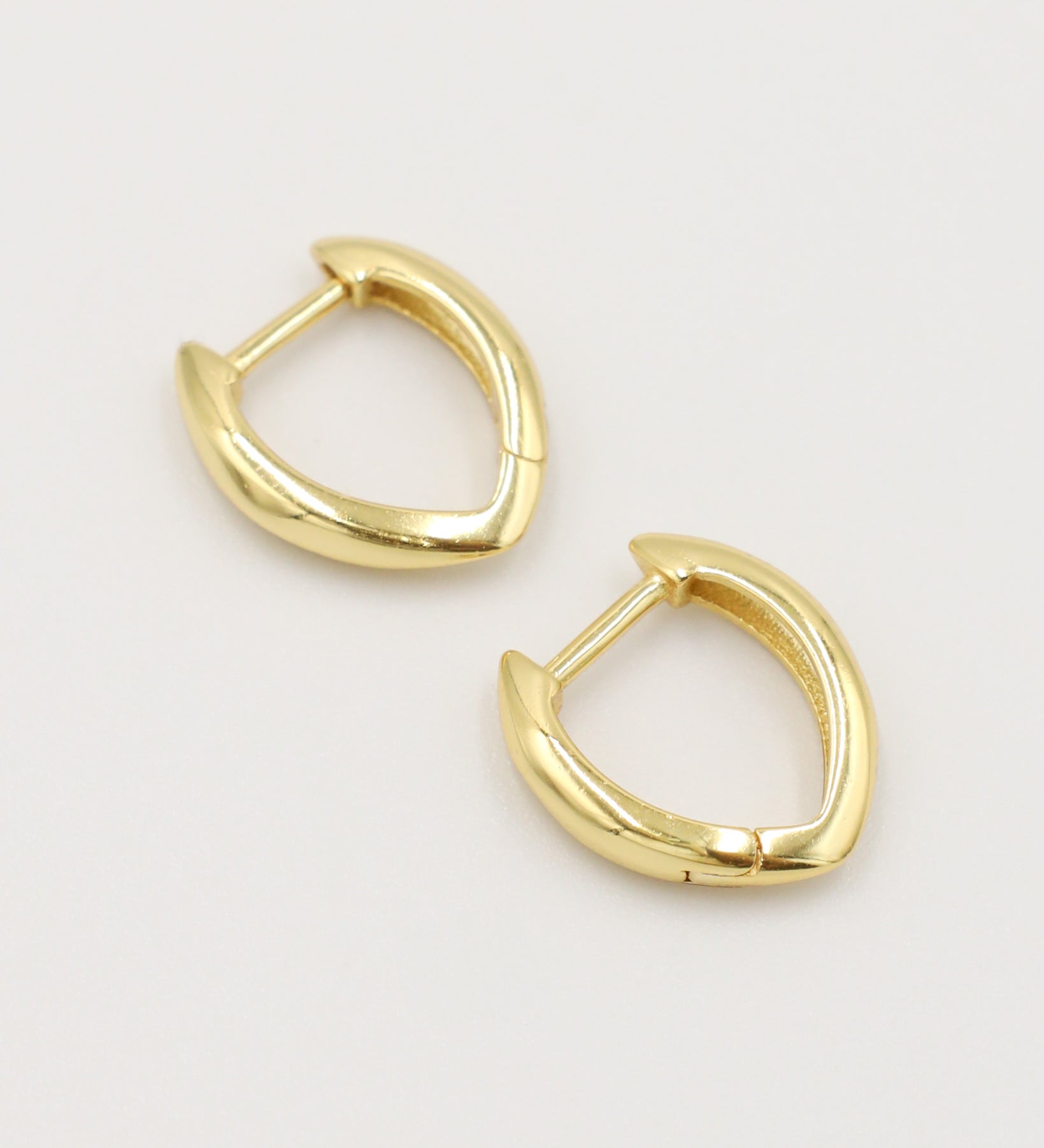 Pair of gold hoop earrings on a white background