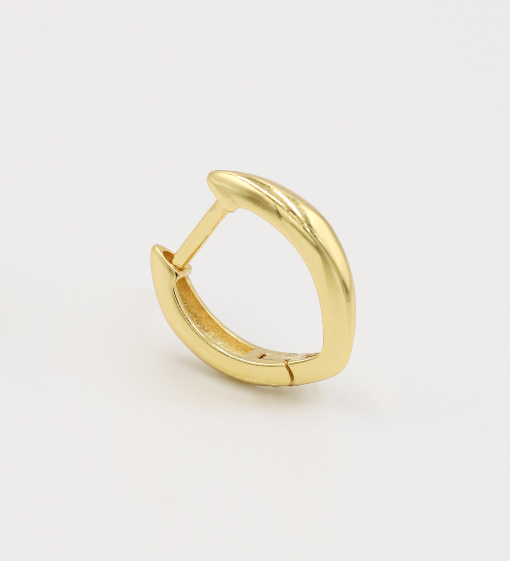 A single gold-colored hoop earring with a hinged clasp, displayed against a white background.