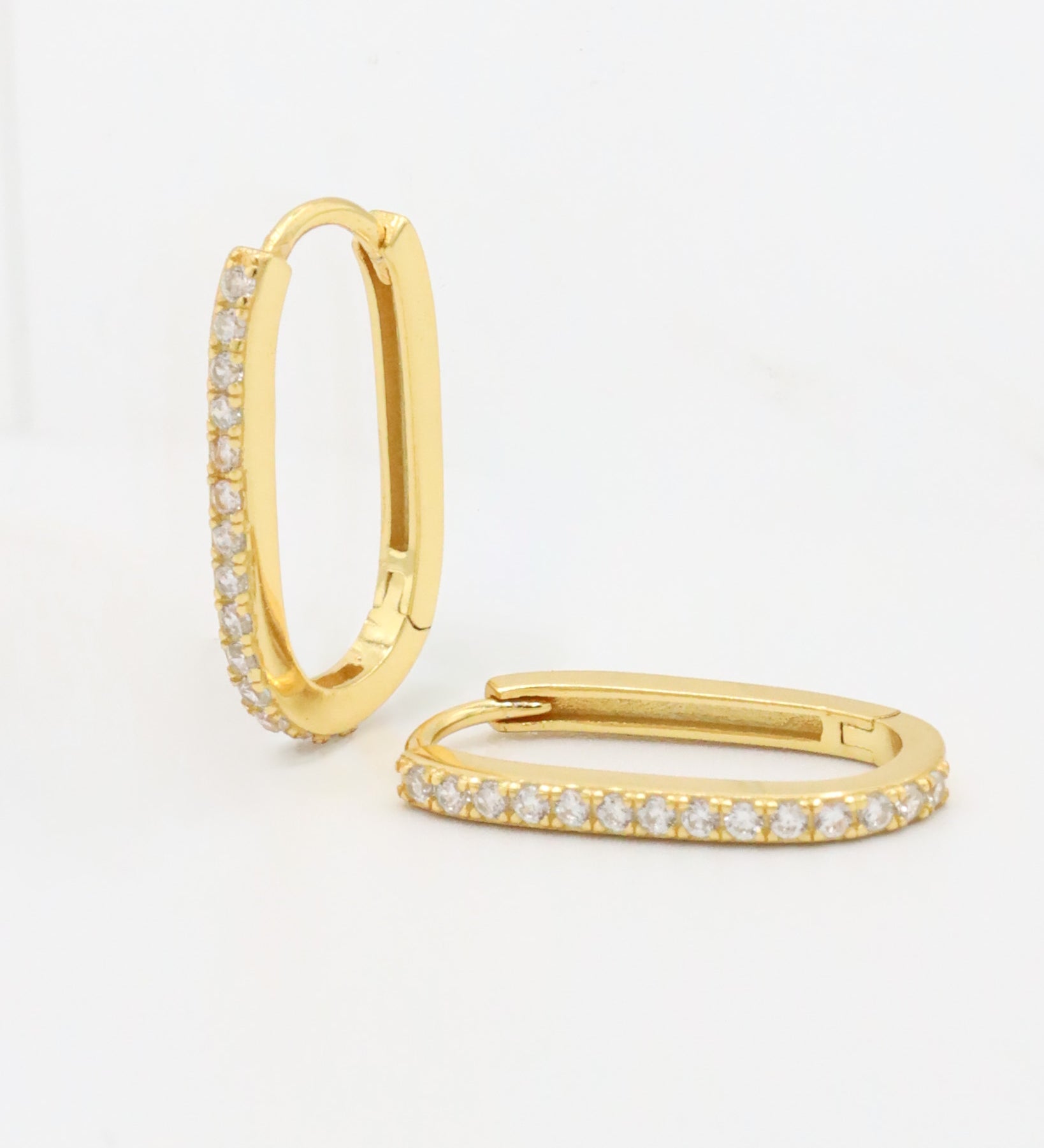 A gold hoop earring with a row of inset stones on the hoop, displayed against a white background.