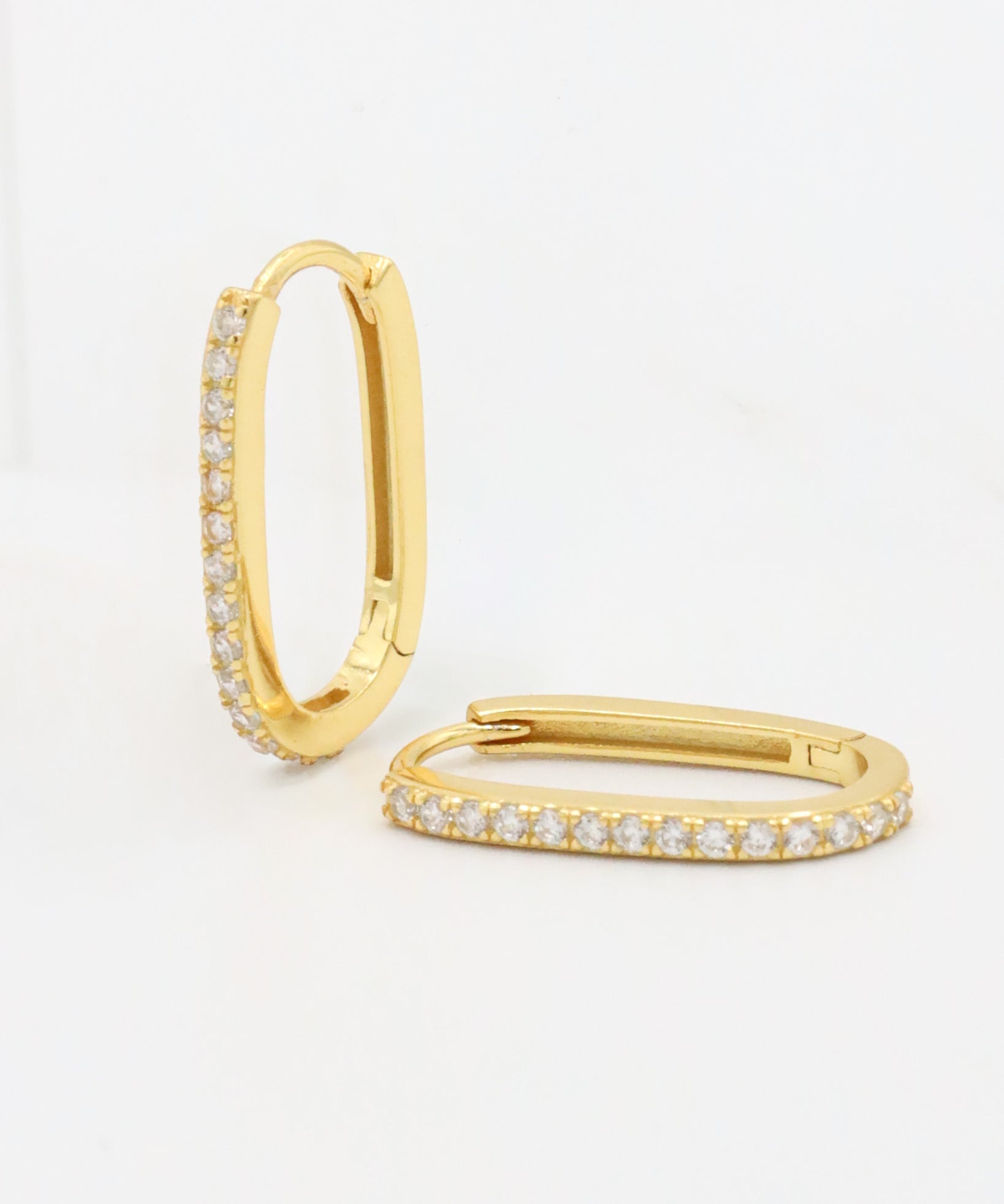 A gold hoop earring with a row of inset stones on the hoop, displayed against a white background.