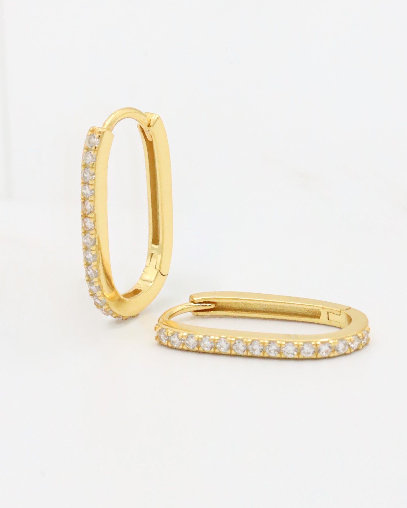 A gold hoop earring with a row of inset stones on the hoop, displayed against a white background.