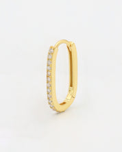 Gold colored hoop earring with a row of inset stones on the hoop, displayed against a white background.