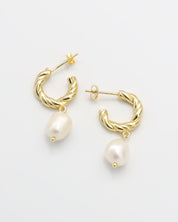 A pair of gold-colored hoop earrings with white pearl accents.