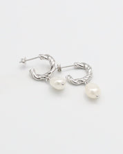 A pair of silver hoop earrings with white pearl studs.