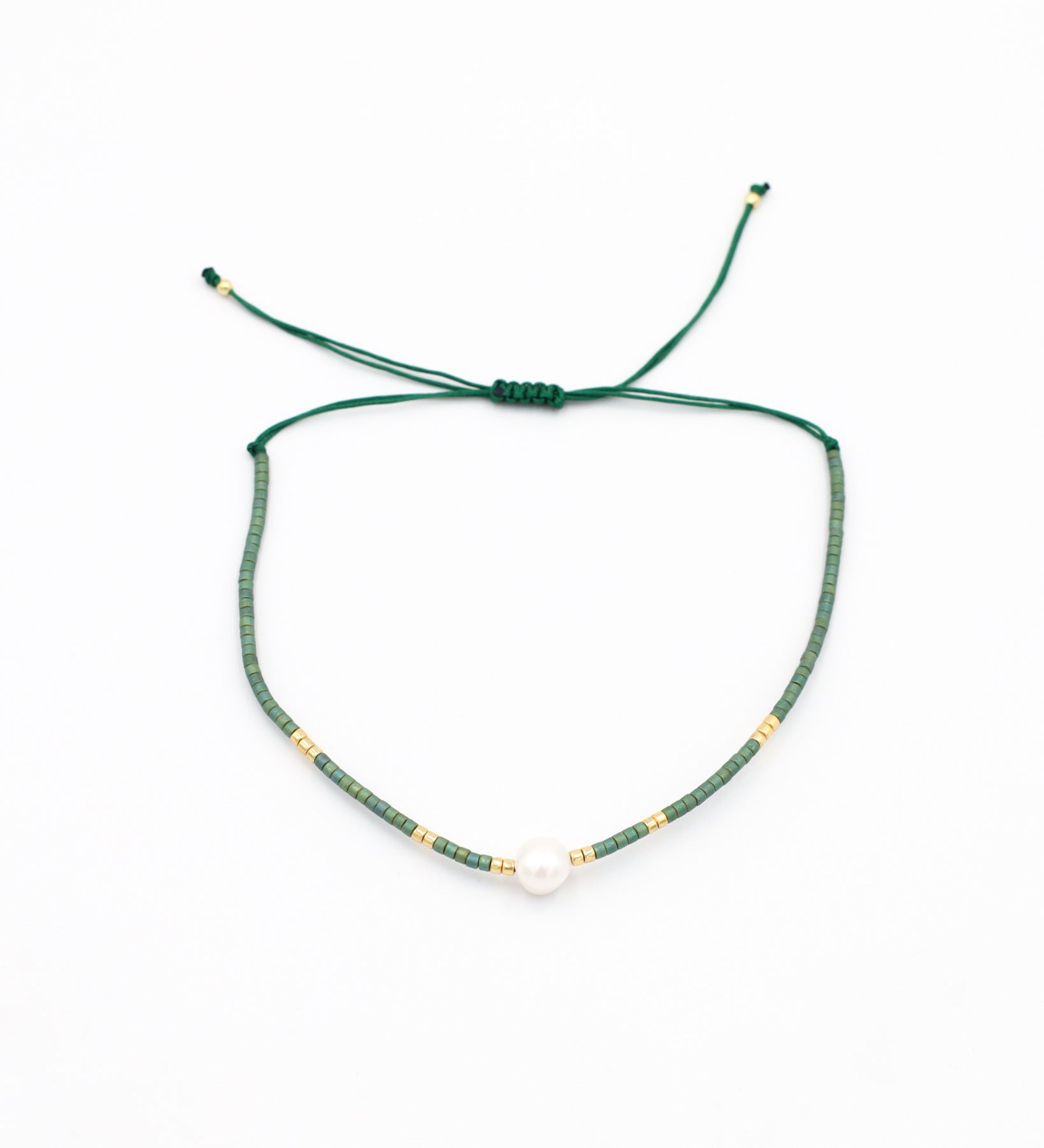 Adjustable bead and rhinestone necklace with a green and gold color scheme.