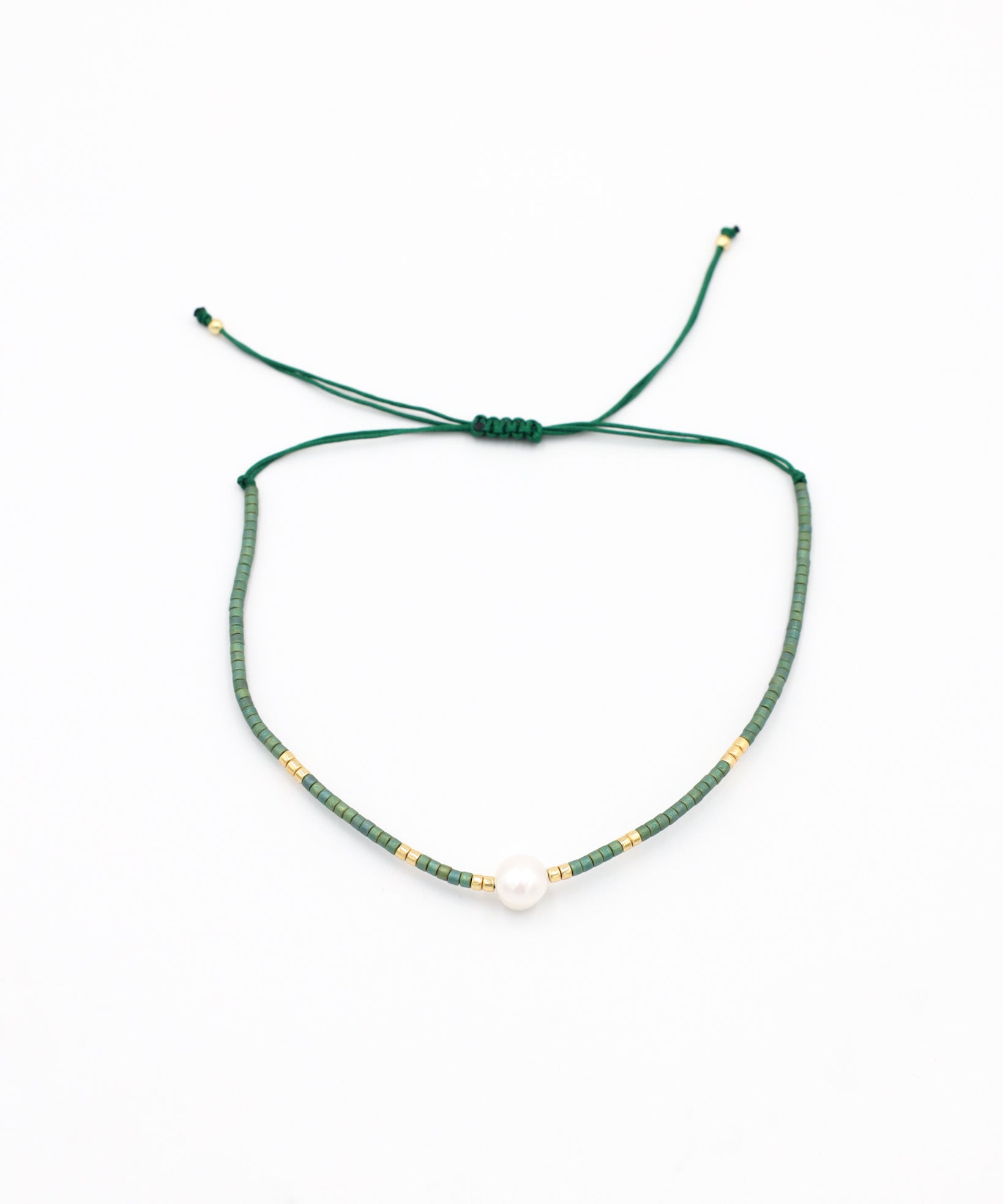 Adjustable bead and rhinestone necklace with a green and gold color scheme.