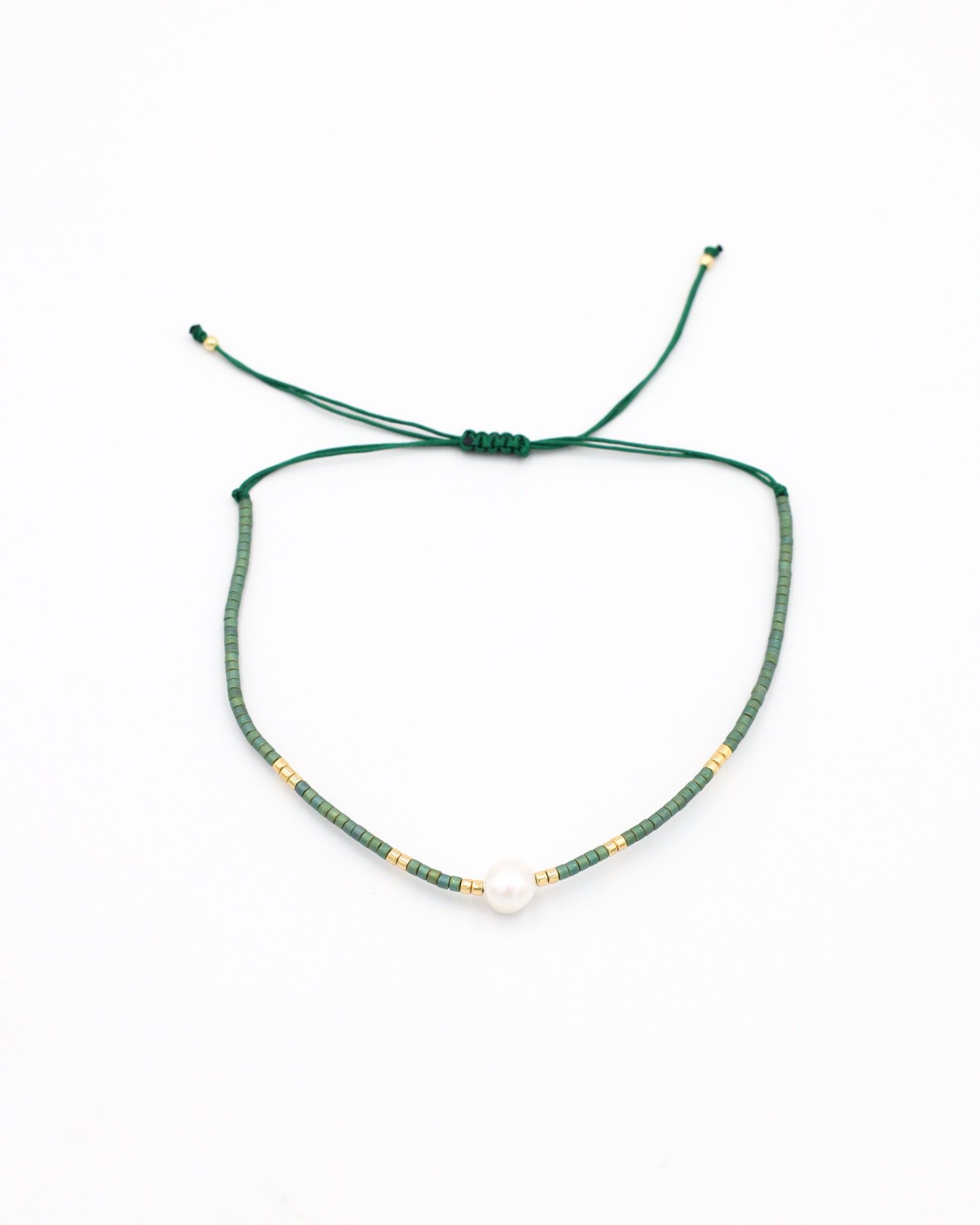 Adjustable bead and rhinestone necklace with a green and gold color scheme.