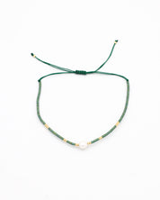 Adjustable bead and rhinestone necklace with a green and gold color scheme.
