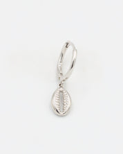 A single silver hoop earring with a small dangling silver charm on a white background