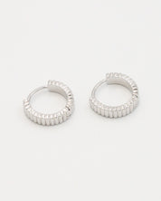 A pair of silver hoop earrings with a textured surface, displayed against a white background.