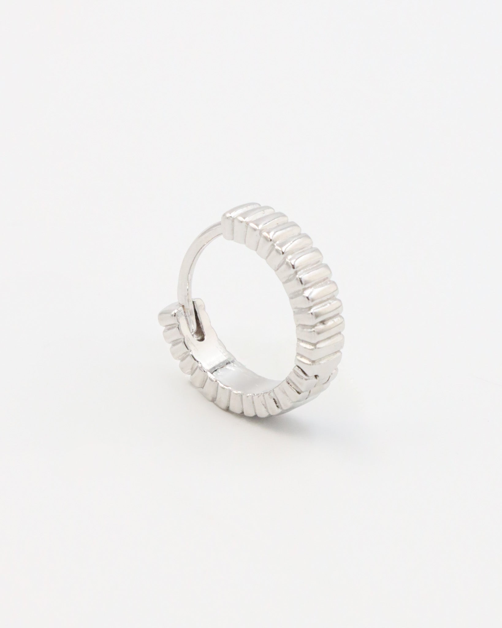 A pair of silver hoop earrings with a textured surface, displayed against a white background.