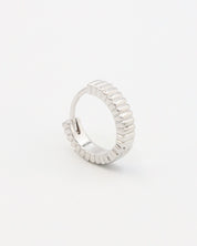 A pair of silver hoop earrings with a textured surface, displayed against a white background.