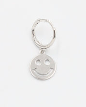 A silver hoop charm with a smiley face design on it.