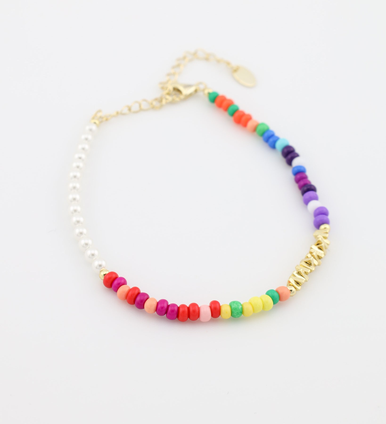 Colorful beaded bracelet with gold chain on a white background