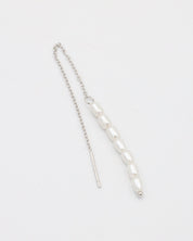 A silver necklace with two white beads on a chain, laid out against a white background.