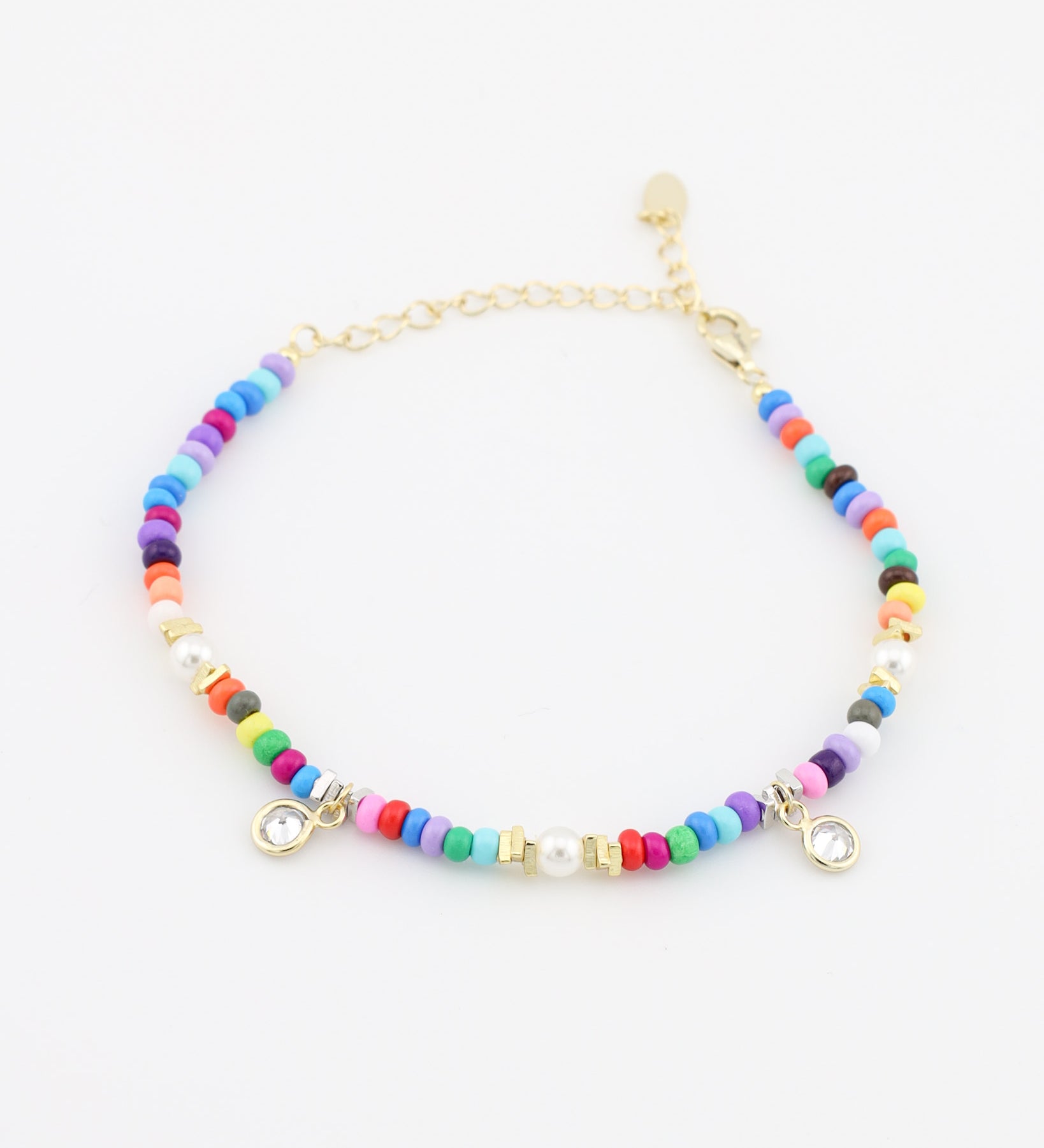 Multicolored beaded bracelet with gold accents on a white background