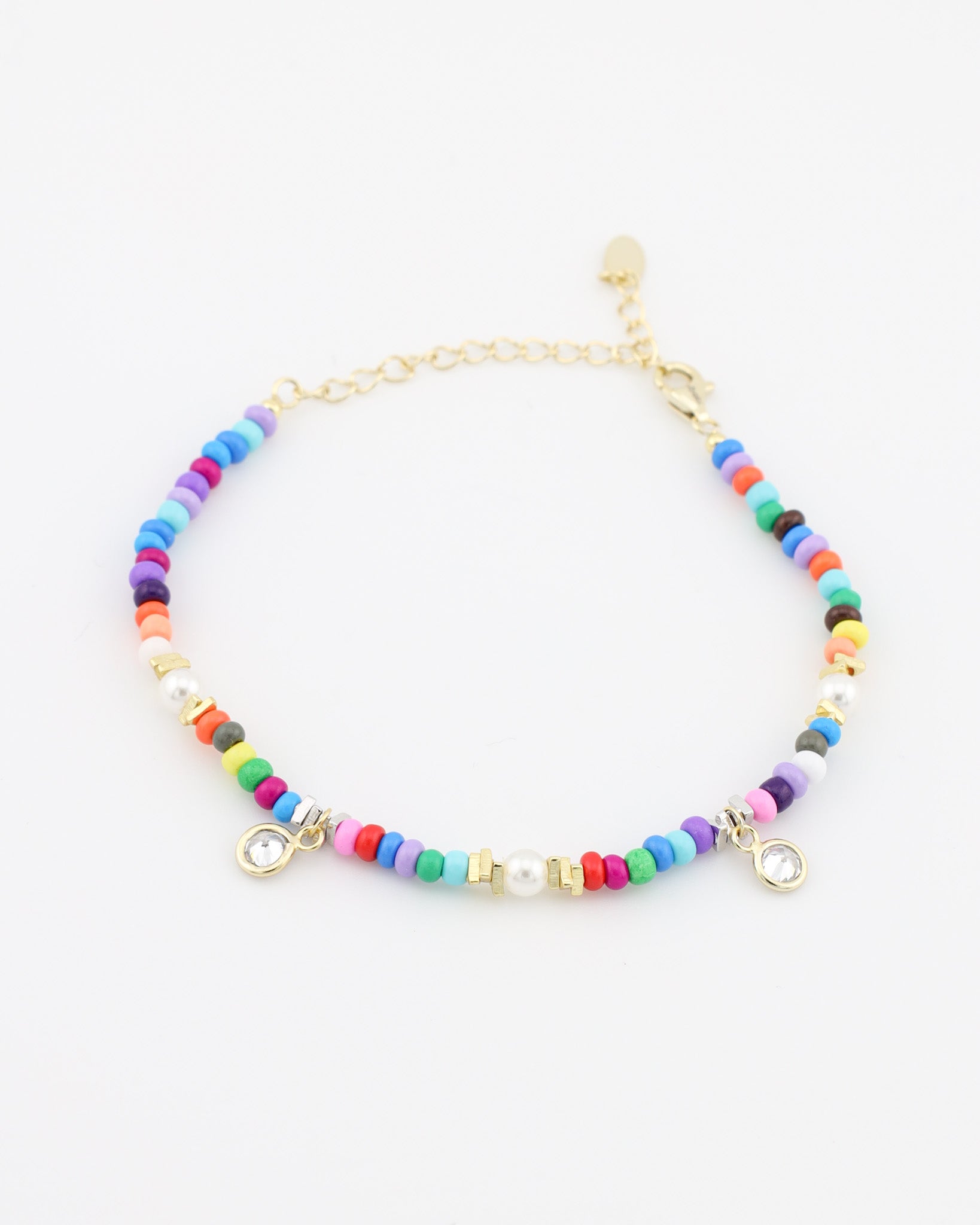 Multicolored beaded bracelet with gold accents on a white background