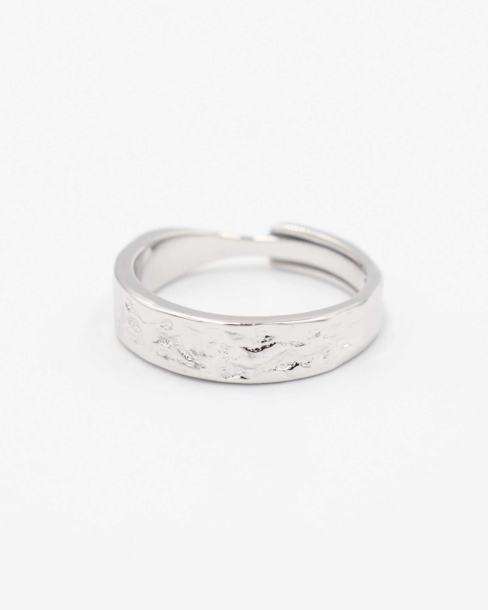A simple silver ring with a textured surface, displayed against a white background.
