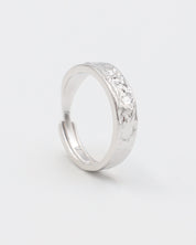 A simple silver ring with a textured surface, displayed against a white background.