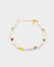 Adjustable gold-plated sterling silver pearl bracelet with colorful beads, Moe Gold, angled view.