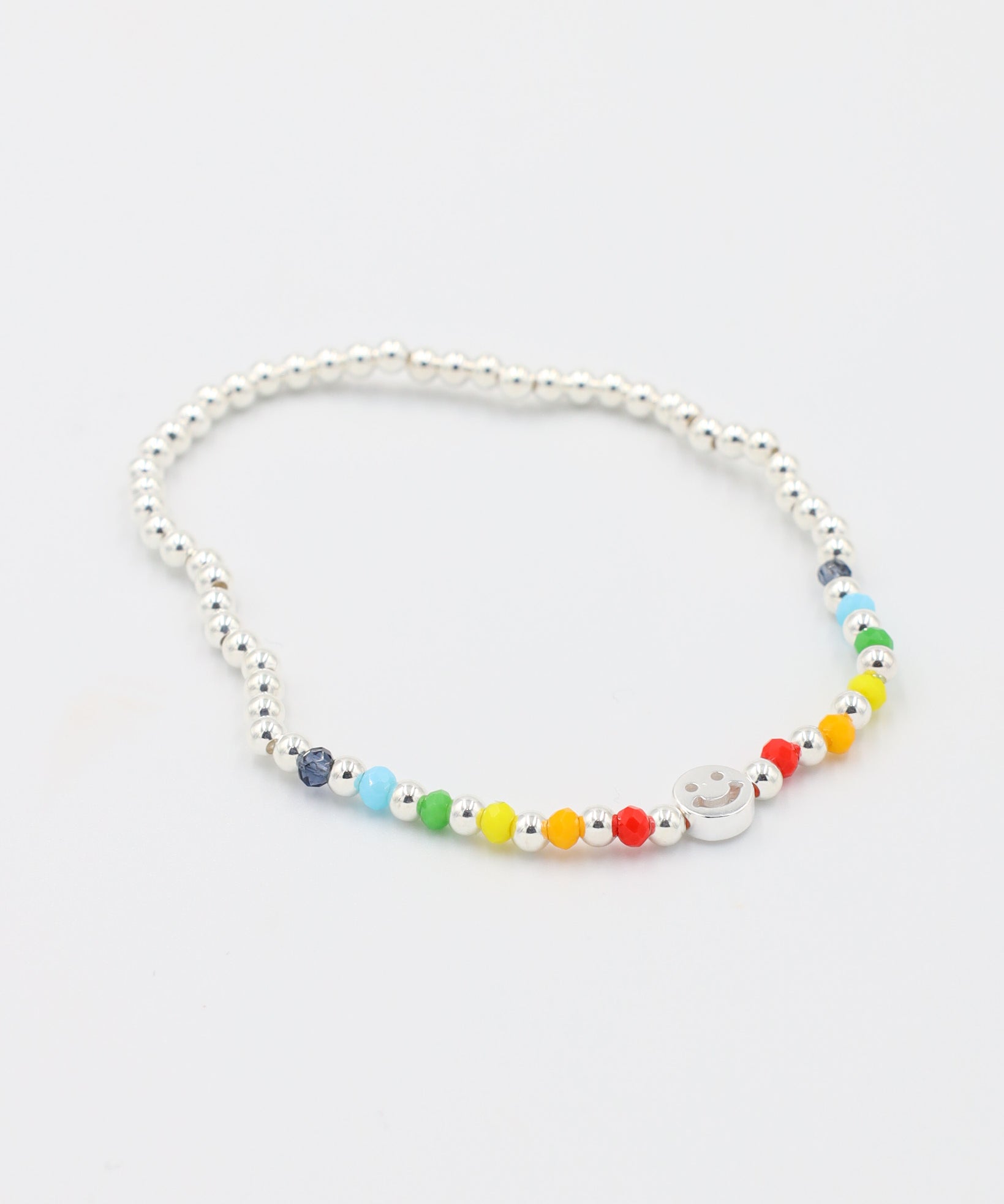 Adjustable sterling silver Pietro bracelet featuring a smiley charm and colorful accent beads, angled view.