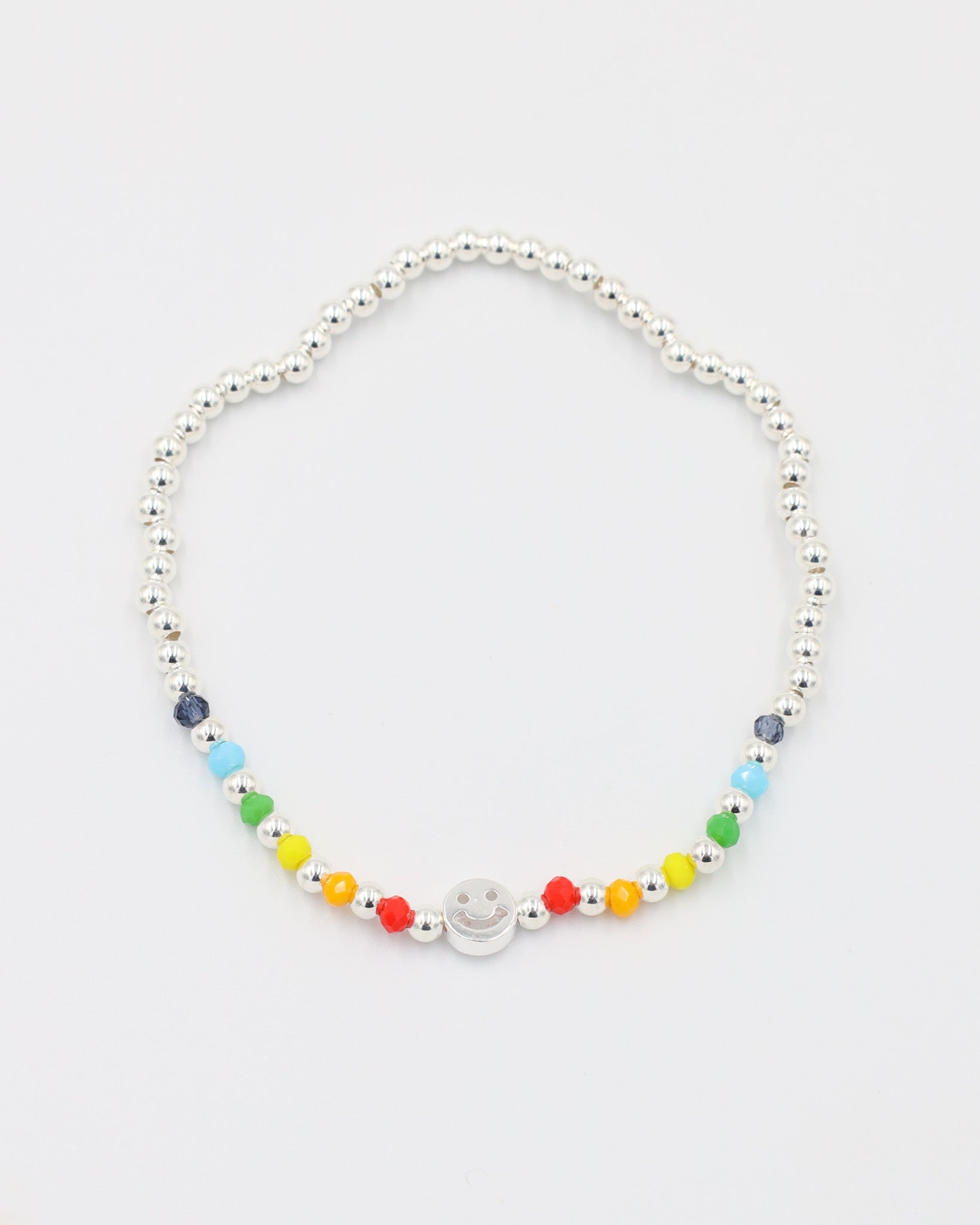 Adjustable sterling silver Pietro bracelet with a smiley charm, top view with colorful accent beads.