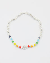 Adjustable sterling silver Pietro bracelet with a smiley charm, top view with colorful accent beads.