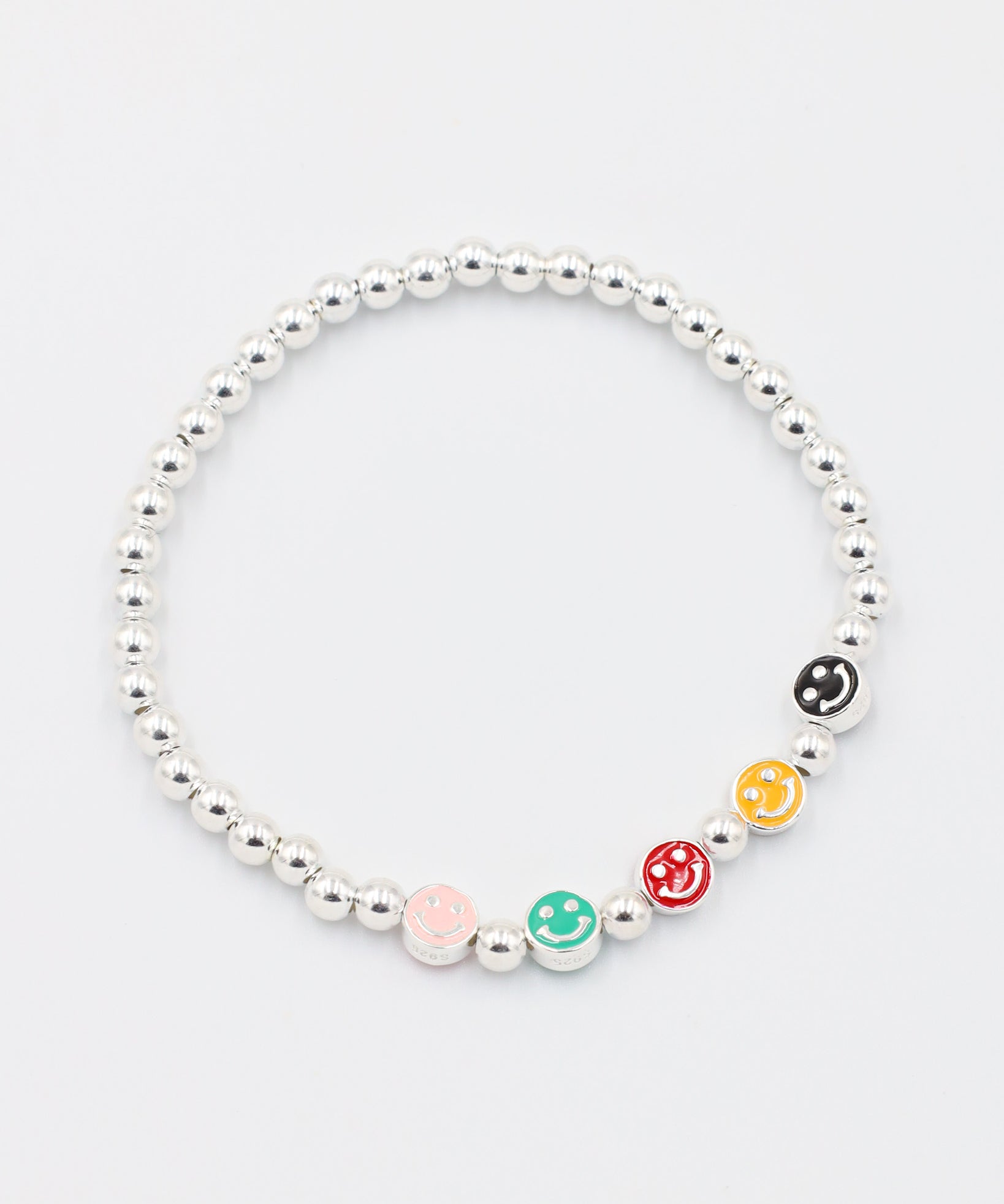 Top view of adjustable sterling silver bracelet with colored smiley face beads and round silver beads.