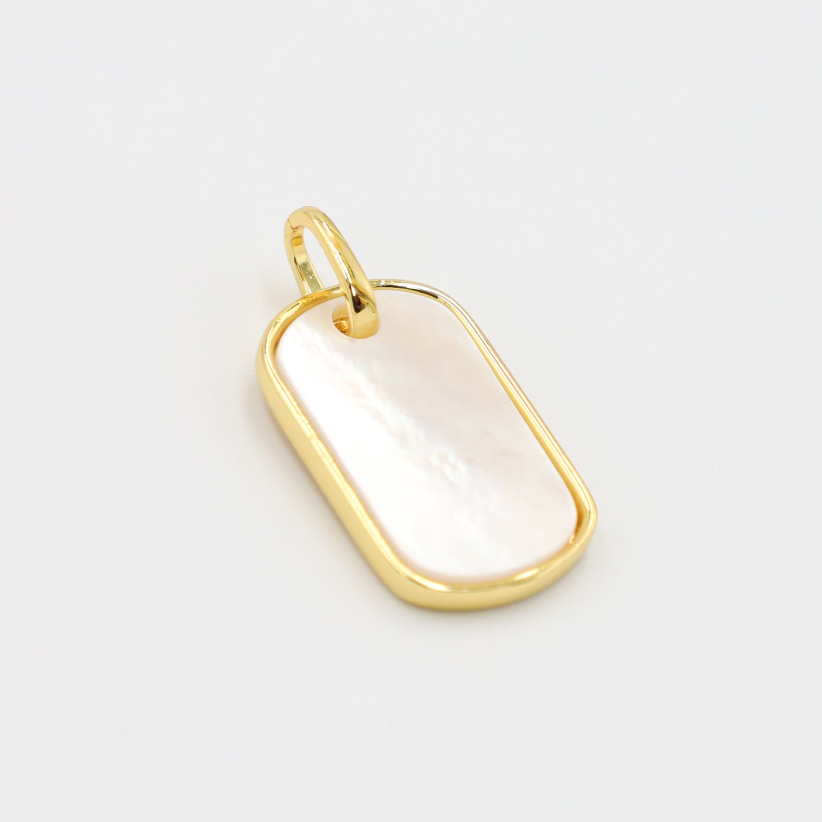 Angled view of the Amara pendant, highlighting the glossy enamel and gold-plated finish.