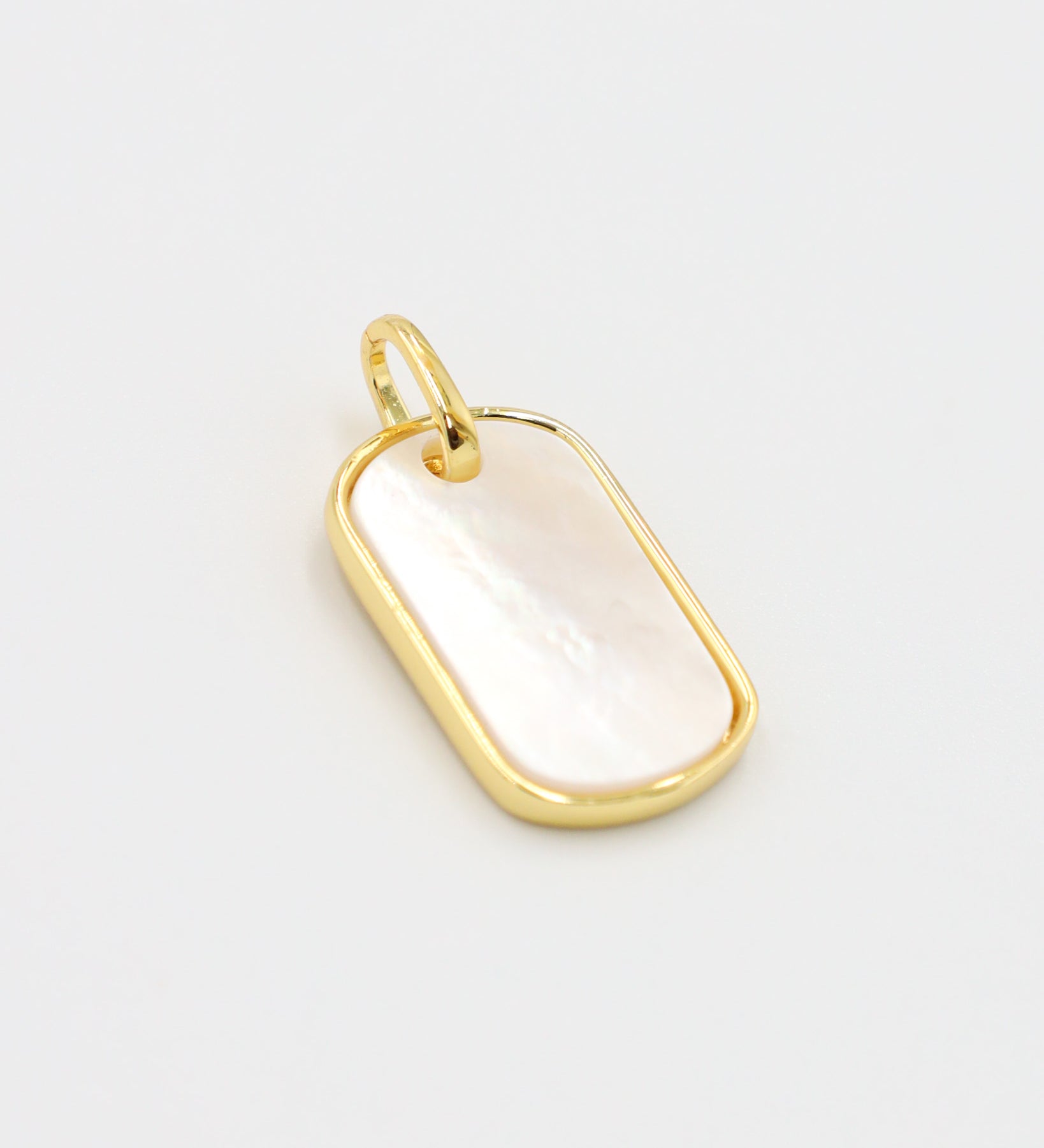 Angled view of the Amara pendant, highlighting the glossy enamel and gold-plated finish.