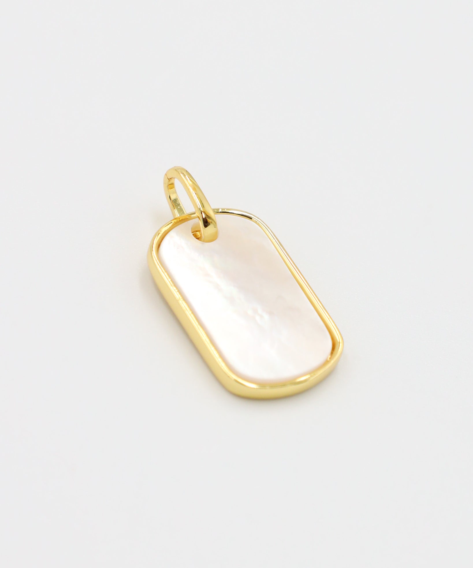 Angled view of the Amara pendant, highlighting the glossy enamel and gold-plated finish.