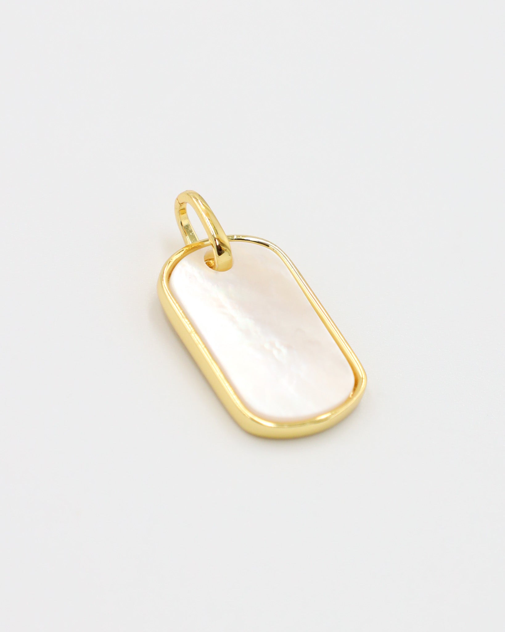 Angled view of the Amara pendant, highlighting the glossy enamel and gold-plated finish.