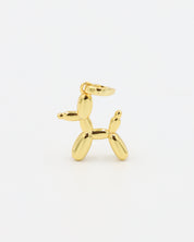Standing view of a gold-plated balloon dog pendant made from sterling silver.
