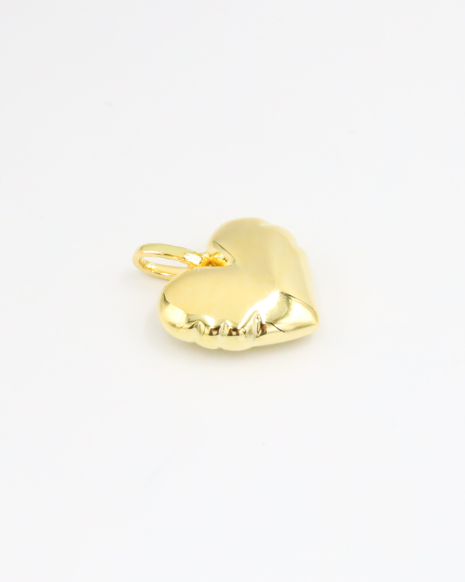 Bella Gold heart-shaped pendant in gold-plated 925 sterling silver shown lying flat on a white surface.