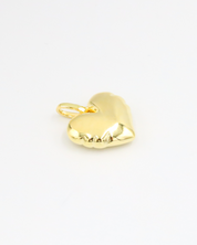 Bella Gold heart-shaped pendant in gold-plated 925 sterling silver shown lying flat on a white surface.