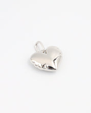 Side view of the Bella Silver heart pendant, showcasing its smooth, sculpted surface in rhodium-plated 925 sterling silver.