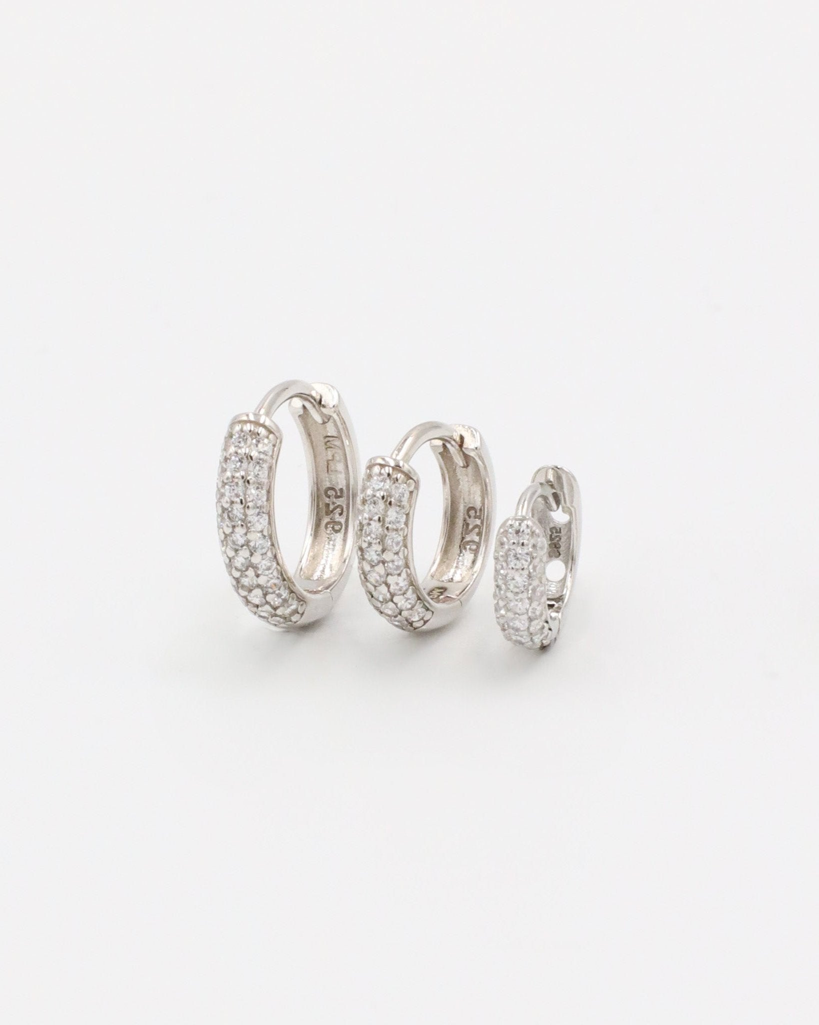 Three sizes of Billie hoop earrings in silver with zirconia stones, displayed from a front view. Sizes shown: S, M, and L.