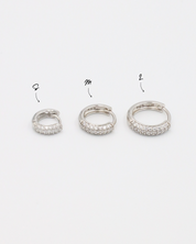 Three sizes of Billie hoop earrings in silver with zirconia stones, displayed from a side view. Sizes shown: S, M, and L.