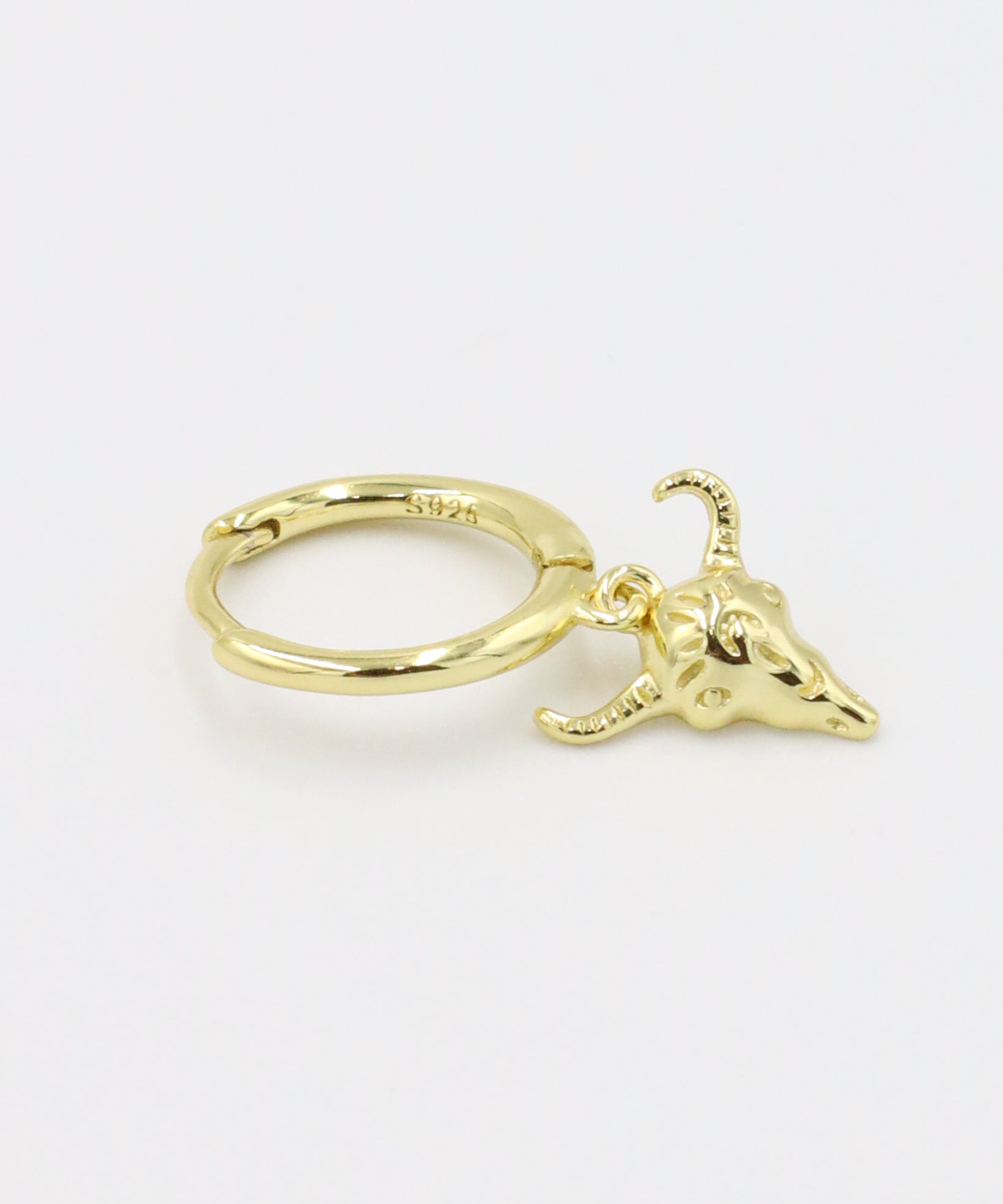 A single gold-plated sterling silver hoop earring with a bull skull charm.