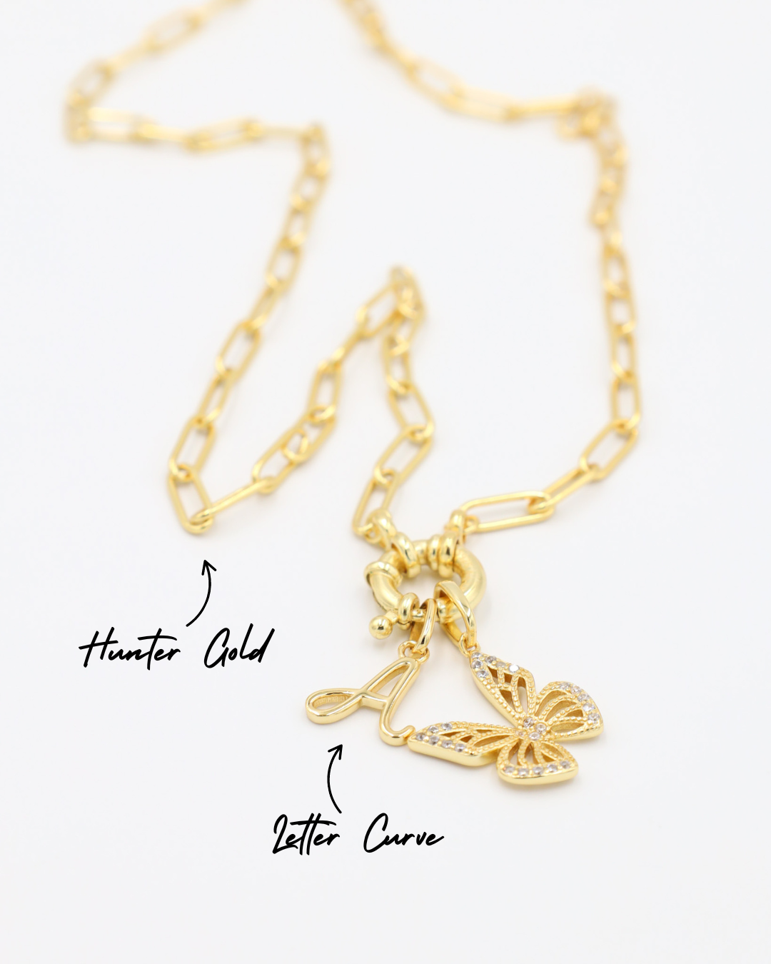 Hunter Gold chain necklace featuring a combination of the Letter Curve "A" pendant and the Butterfly Gold pendant with zirconia stones, all in gold-plated 925 sterling silver.
