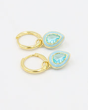 Pair of Cindy Blue earrings made from gold-plated sterling silver, featuring a pear-shaped zirconia stone in a light blue enamel setting.