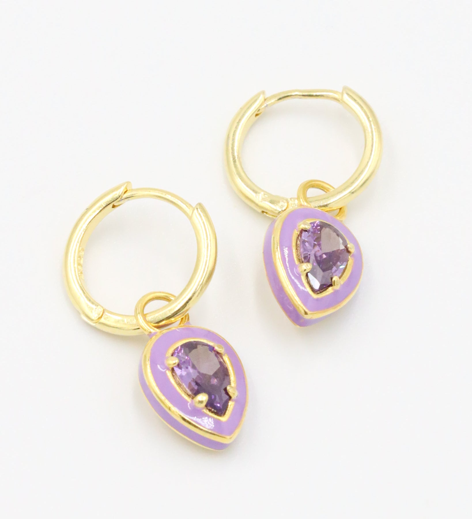 A pair of Cindy Purple earrings made from gold-plated sterling silver with purple zirconia stones and purple enamel detailing.