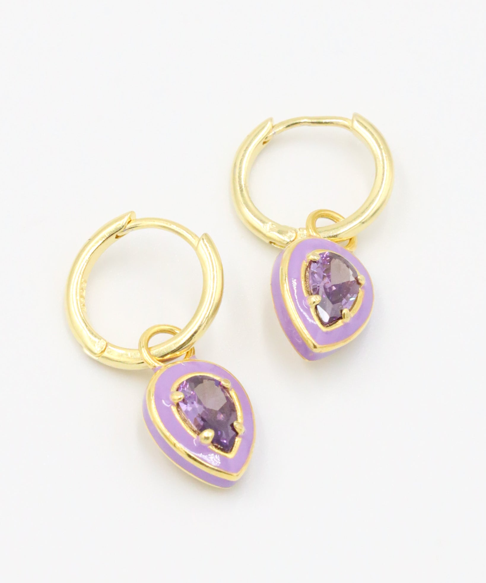 A pair of Cindy Purple earrings made from gold-plated sterling silver with purple zirconia stones and purple enamel detailing.