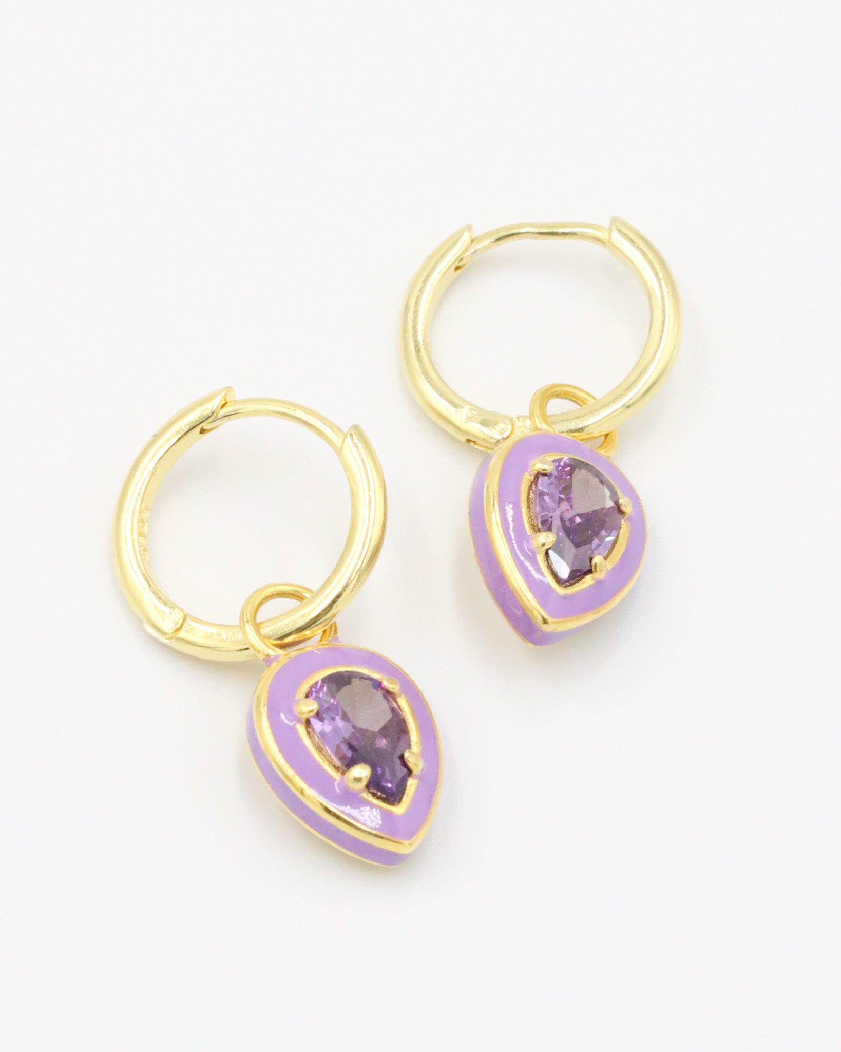 A pair of Cindy Purple earrings made from gold-plated sterling silver with purple zirconia stones and purple enamel detailing.