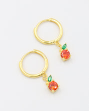 Pair of gold-plated sterling silver hoop earrings with orange zirconia stone and green leaf details, named Clementine.