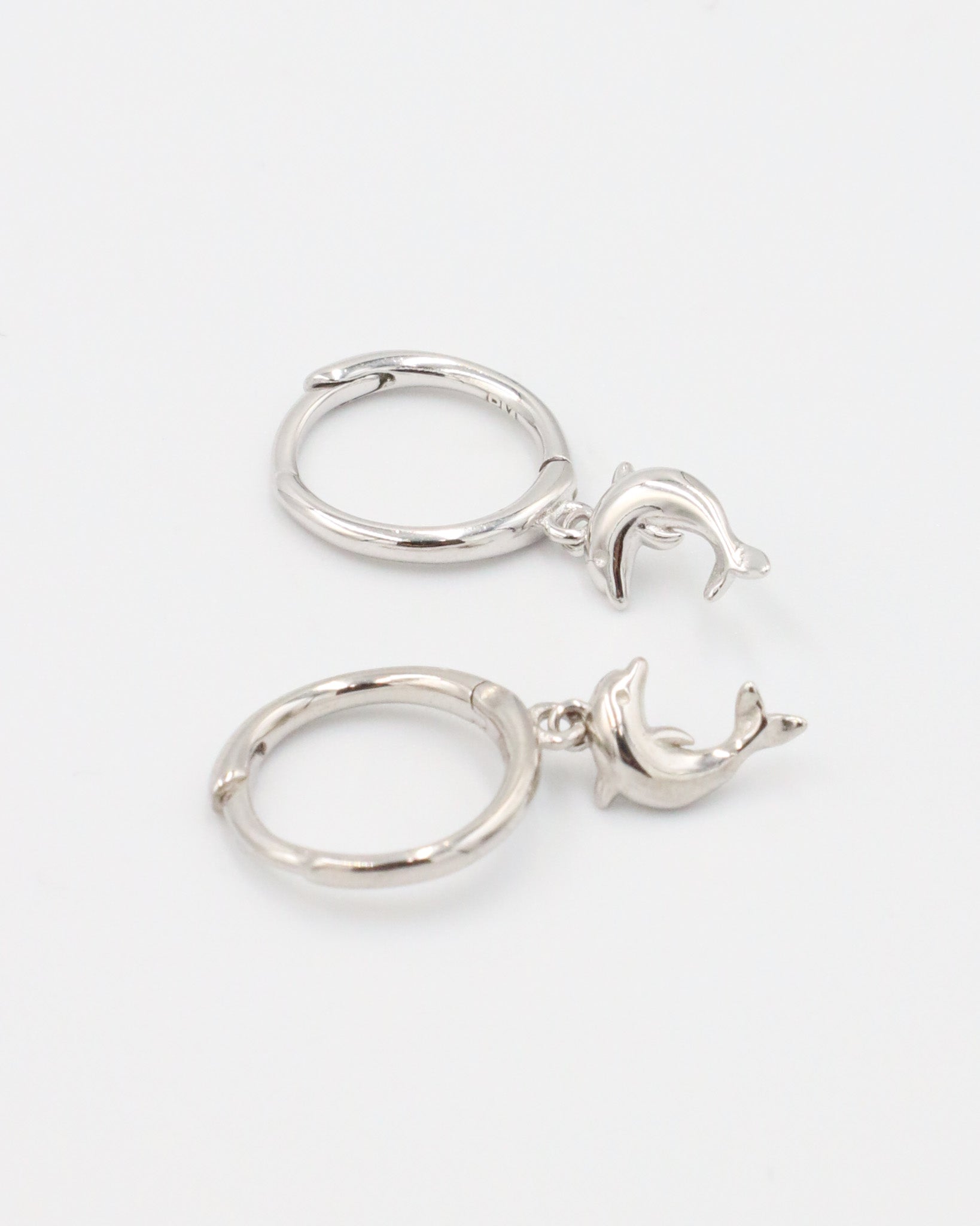 Pair of Dolphin Silver hoop earrings with dolphin charms.
