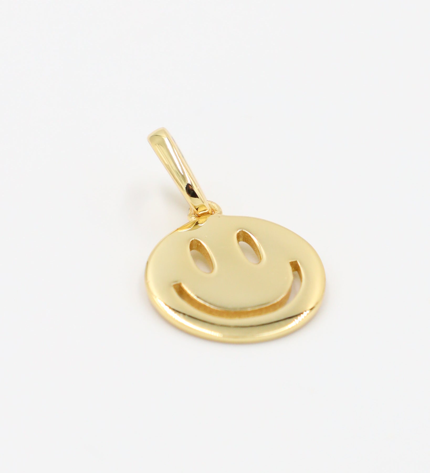 Side view of Flynn Gold smiley face pendant in gold-plated 925 sterling silver.