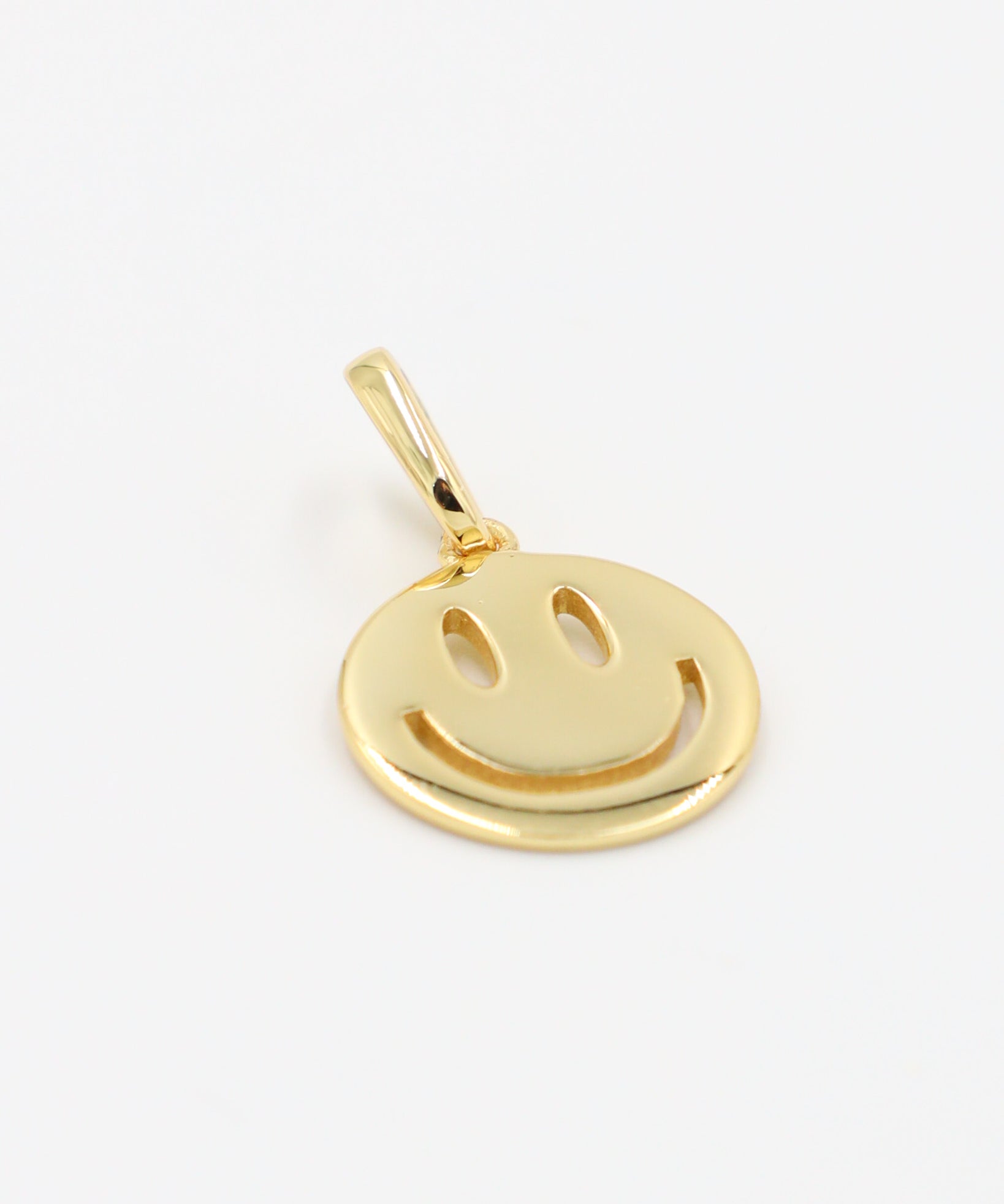 Side view of Flynn Gold smiley face pendant in gold-plated 925 sterling silver.