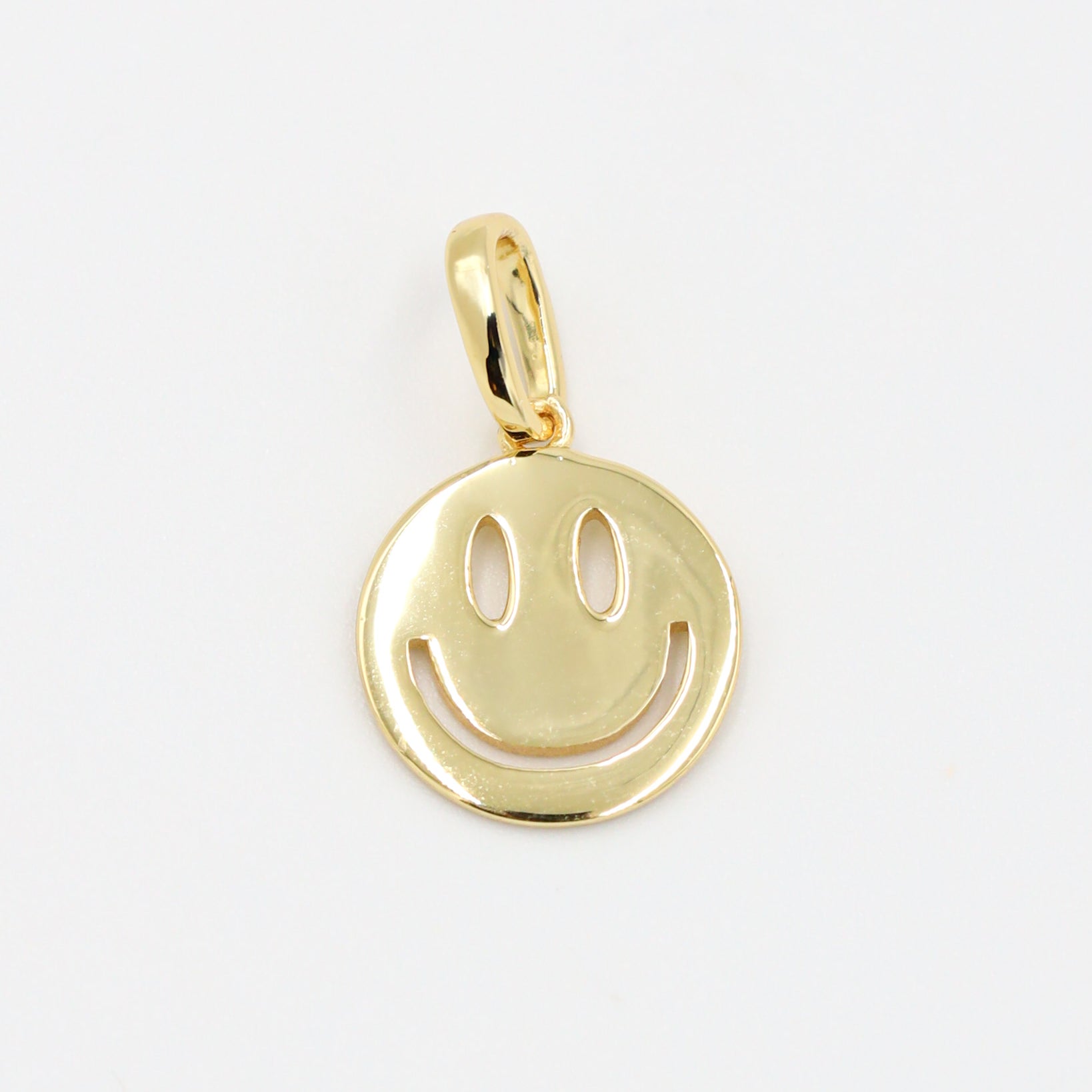 Flynn Gold smiley face pendant crafted in gold-plated 925 sterling silver, shown as a single piece.
