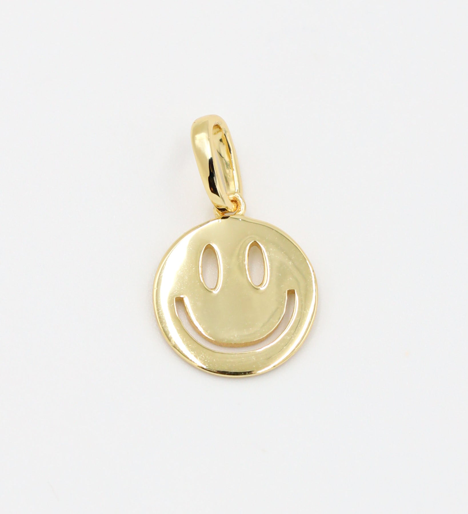 Flynn Gold smiley face pendant crafted in gold-plated 925 sterling silver, shown as a single piece.